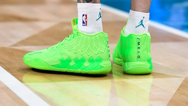 A detailed view of green Puma shoes.